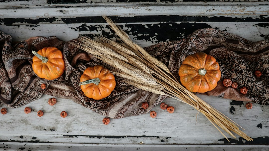 Autumn table decorated with pumpkins and wheat for a Thanksgiving gathering
